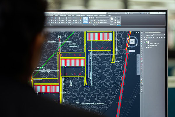Engineer reviewing a detailed solar panel system design on a CAD software screen. ARC Renewables specialises in custom solar energy solutions, from planning to installation, for commercial and industrial projects.